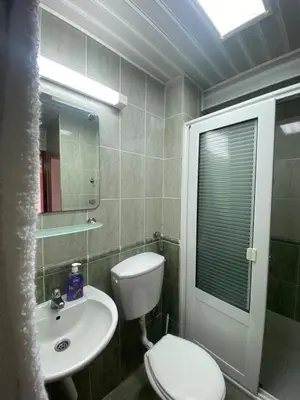 a bathroom with a white toilet and a sink at DeLux Apartmani in Dobra Voda