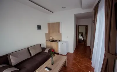 a living room with a couch and a table at DeLux Apartmani in Dobra Voda