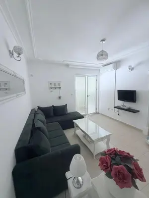 a living room with a couch and a table at Apartman Na pjenu od mora Becici in Budva