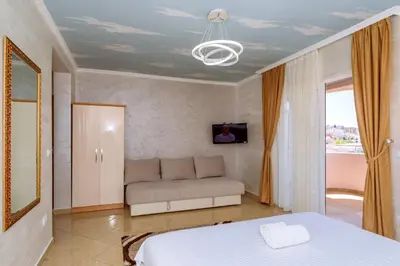 a living room with a bed and a couch at Ani Lux in Dobra Voda