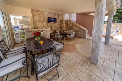 a living room with a stone wall at Ani Lux in Dobra Voda