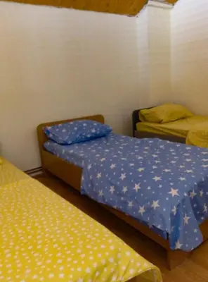 a room with two beds and a bedskirts at Vila Natalija in Podgorica