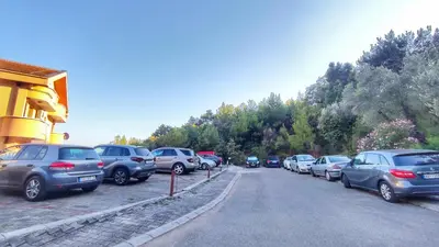 a bunch of cars parked on the side of a road at Jardin de fleurs in Petrovac na Moru