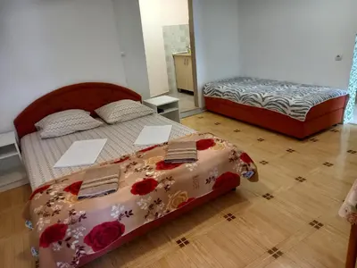 a bedroom with two beds with flowers on it at Bugenvilija in Budva