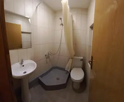 a bathroom with a sink and a toilet and a sink at Bugenvilija in Budva