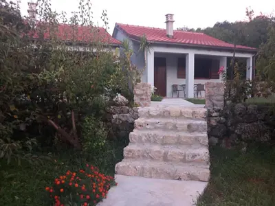 a house with a stone staircase in front of a yard at Rustic Village House 4 in Rijeka Crnojevića