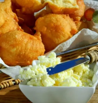 a white bowl of food with a spoon in it at Villa Natalija in Podgorica