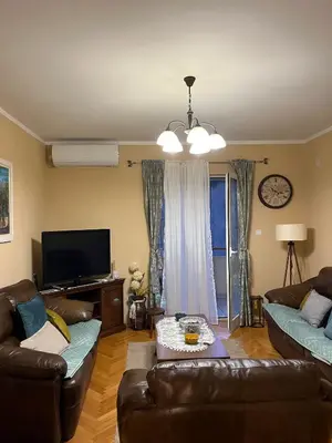 a living room with two couches and a tv at Apartman Nina in Kotor