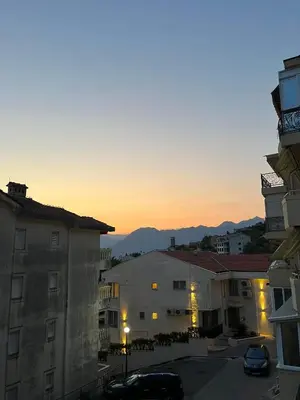 a sunset view of a city with buildings at Apartman Nina in Kotor
