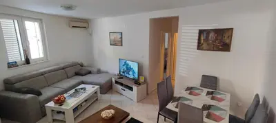 a living room with a couch and a table at Tomopet Apartment in Petrovac na Moru