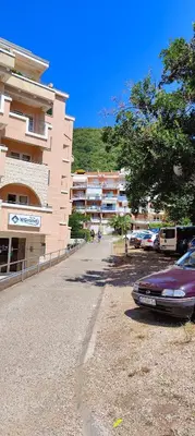 a car parked in a parking lot next to a building at Tomopet Apartment in Petrovac na Moru