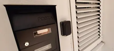 a mail box with a postal sign on it at Tomopet Apartment in Petrovac na Moru