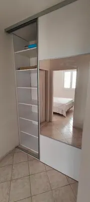 a reflection of a closet with a mirror in a room at Tomopet Apartment in Petrovac na Moru