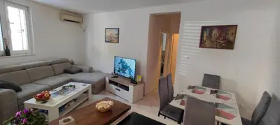 a living room with a couch and a table at Tomopet Apartment in Petrovac na Moru