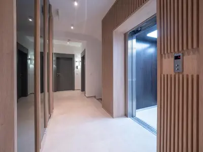 a corridor in a building with glass doors at Horizon one bedroom apartment NS in Becici