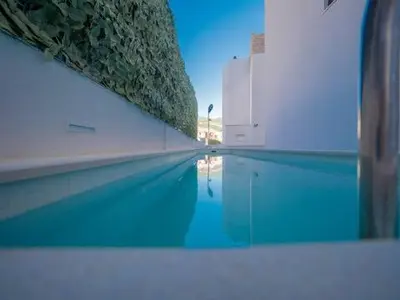 a swimming pool with blue water next to a building at Horizon one bedroom apartment NS in Becici