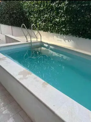 a swimming pool with a sign in the middle of it at Horizon one bedroom apartment NS in Becici