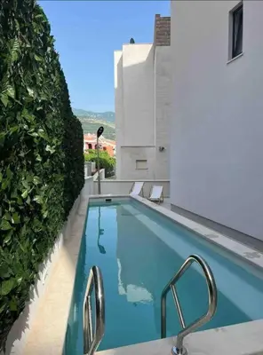 a swimming pool on the side of a building at Horizon one bedroom apartment NS in Becici