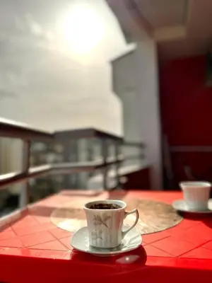 a cup of coffee sitting on a red table at Apartman Filip in Podgorica