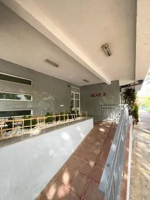 a building with a balcony with plants on it at Apartman Filip in Podgorica