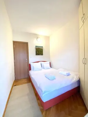 a bedroom with a large bed with two pillows at Apartman Filip in Podgorica