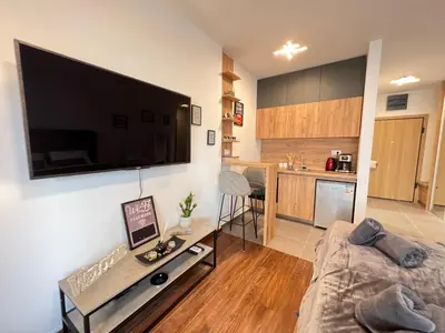 a living room with a large flat screen tv on the wall at White Homes 16 - Master Quart in Podgorica