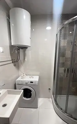 a bathroom with a washing machine and a sink at White Homes 16 - Master Quart in Podgorica