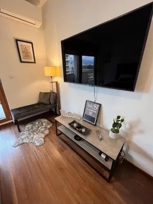 a living room with a large flat screen tv on a wall at White Homes 16 - Master Quart in Podgorica