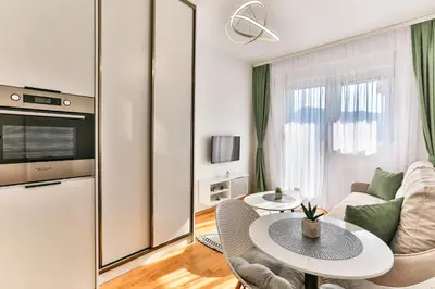 a living room with a table and a couch at Sonja Apartment in Budva