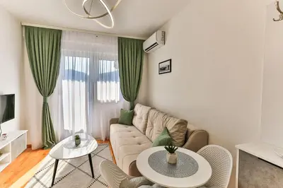 a living room with a couch and a table at Sonja Apartment in Budva
