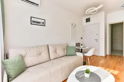 a living room with a couch and a table at Sonja Apartment in Budva