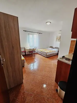 a room with a room with a bed and a table at Apartmani MIM in Bar