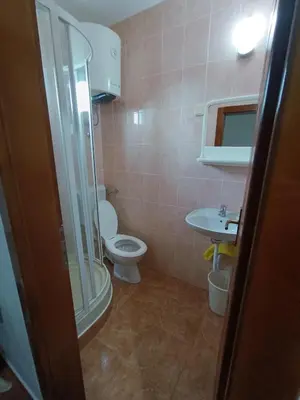 a bathroom with a shower and a toilet and a sink at Apartmani MIM in Bar