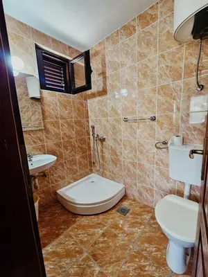 a bathroom with a toilet and a sink at Apartmani MIM in Bar