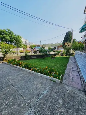 a garden with flowers on the side of a road at Apartmani MIM in Bar