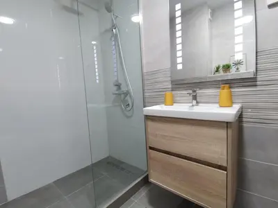 a bathroom with a sink and a shower at Cozy One-Bedroom Apartment at Ljubovic Park in Podgorica