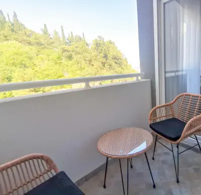 two chairs and a table in front of a window at Cozy One-Bedroom Apartment at Ljubovic Park in Podgorica