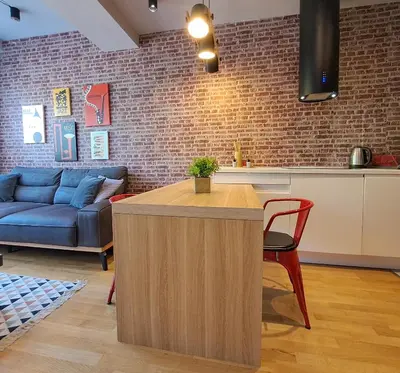 a living room with a couch and a table at Cozy One-Bedroom Apartment at Ljubovic Park in Podgorica