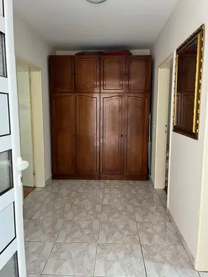 a room with a wooden door and a tile floor at Gorica hill apartment in Podgorica