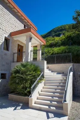 a building with stairs in front of a house at Villa Gradina in Budva
