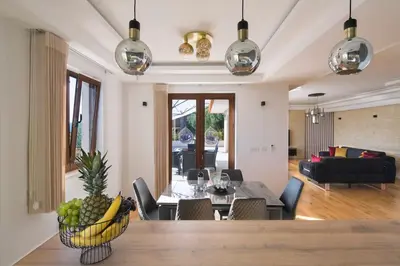 a dining room and living room with a dining table at Villa Gradina in Budva