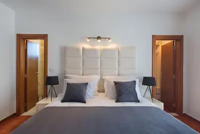 a bedroom with a large bed with three pillows at Villa Gradina in Budva