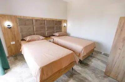 a room with two beds in a room at Apartments Posejdon Lux in Utjeha