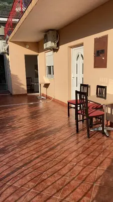 an empty patio with a table and chairs on a wooden floor at Sun-Love in Sutomore
