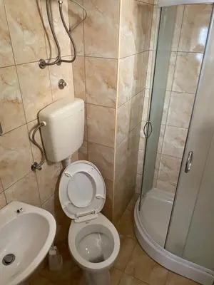 a bathroom with a toilet and a shower and a sink at Sun-Love in Sutomore