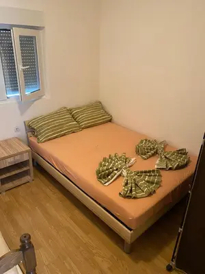 a bed in a room with two pillows on it at Sun-Love in Sutomore
