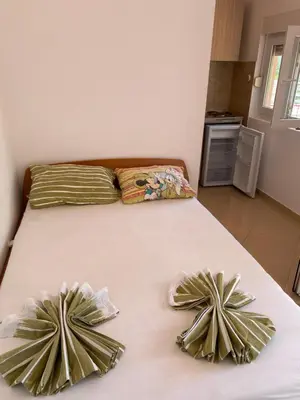 a bed with two pillows on top of it at Sun-Love in Sutomore