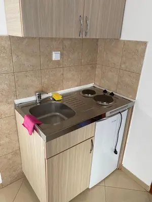 a small kitchen with a sink and a stove at Sun-Love in Sutomore