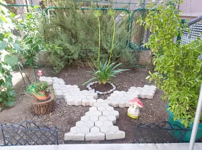 a garden with a fence and some plants and trees at Apartment Marina in Kotor