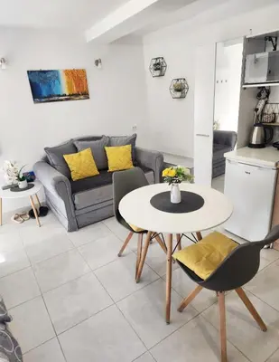 a living room with a table and a couch at Apartment Marina in Kotor